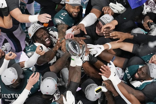 Philadelphia Eagles players celebrate with the Vince Lombardi Trophy after the Eagles won the NFL Super Bowl 59 football game against the Kansas City Chiefs on February 9, 2025, in New Orleans.
