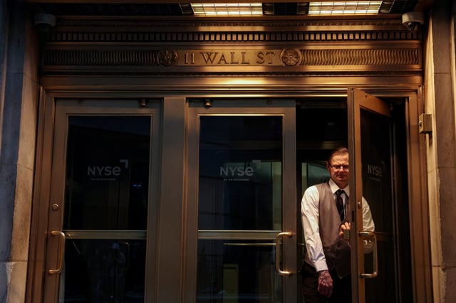 A man exits the New York Stock Exchange (NYSE) onto Wall Street in New York City, U.S., April 7, 2025.  REUTERS/Brendan McDermid