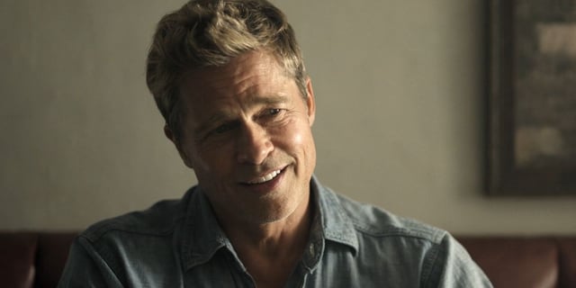 Brad Pitt smiling in a bar in F1.