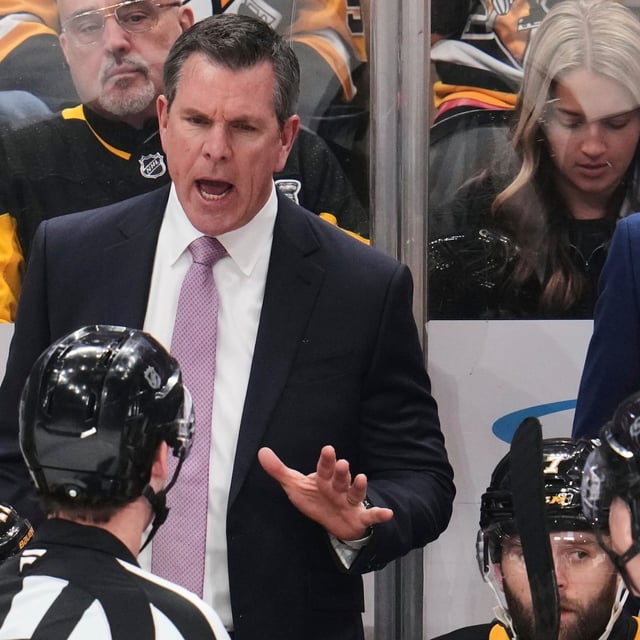 Pittsburgh Penguins head coach Mike Sullivan talks with referee Brandon Schrader during the third period of an NHL hockey game against the Washington Capitals in Pittsburgh, Thursday, April 17, 2025. (AP Photo/Gene J. Puskar)