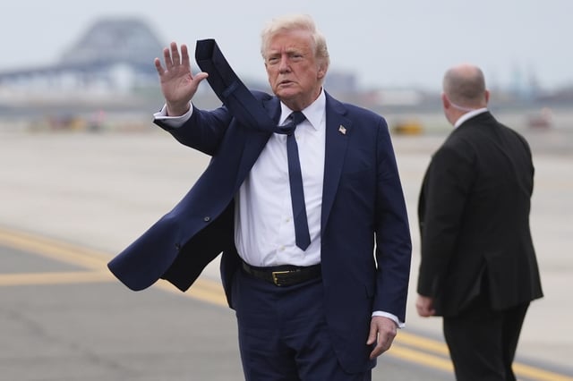 President Donald Trump waves as he arrives at Newark Liberty International Airport in Newark, N.J., Saturday, April 26, 2025, upon returning from a trip to attend the funeral of Pope Francis at the Vatican. (AP Photo/Evan Vucci)