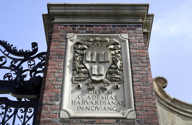 FILE - In this Sunday, March 13, 2016 photo, a relief sculpture rests on a gate to the entrance of Harvard University, in Cambridge, Mass. (AP Photo/Steven Senne, File)