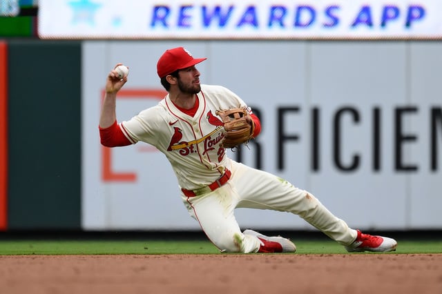 ST LOUIS, MISSOURI - APRIL 26: Thomas Saggese #25 of the St. Louis Cardinals throws to first off a single from Christian Yelich #22 of the Milwaukee Brewers during the first inning at Busch Stadium on April 26, 2025 in St Louis, Missouri.