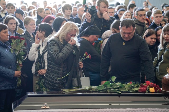 KYIV, UKRAINE – APRIL 28: Relatives and friends attend the farewell ceremony for 17-year-old Danylo Khudei and his parents, father Oleh and mother Viktoriia, who were killed during a Russian missile strike on April 28, 2025 in Kyiv, Ukraine. A farewell ceremony was held at Baikove Cemetery for 17-year-old Danylo Khudei and his parents — father Oleh and mother Viktoriia — who were killed in the Russian missile strike on the Sviatoshynskyi district during the night of April 24. 