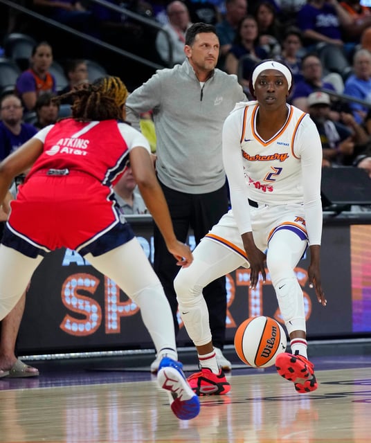 Mercury guard Kahleah Copper (2) dribbles in front of her head coach Nate Tibbetts against Mystics guard Ariel Atkins (7) during a game at the Footprint Center in Phoenix at Thursday, May 23, 2024.