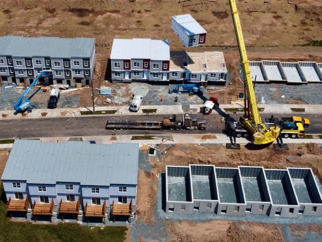 A prefab unit is lowered into place at a housing development under construction in Dartmouth in July 2024.