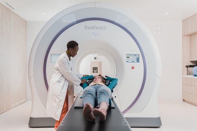 Accuray Radixact machine with patient being positioned and accompanied by therapist on August 26-27 in Geneva, Swiss Confederation.