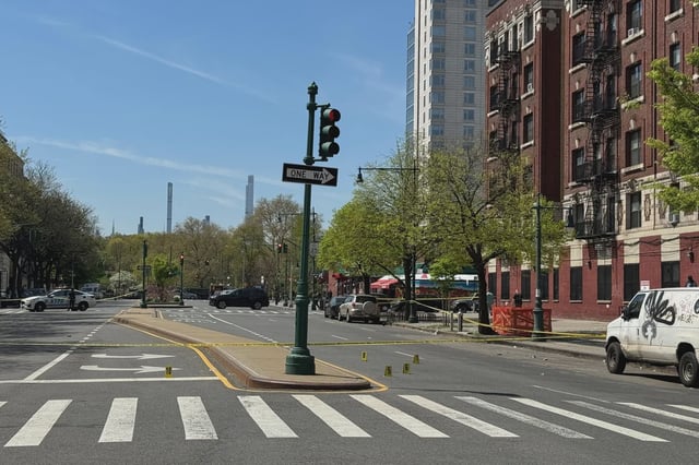 Evidence markers are seen on the street at Malcolm X Boulevard and West 113rd Street on April 23, 2025.