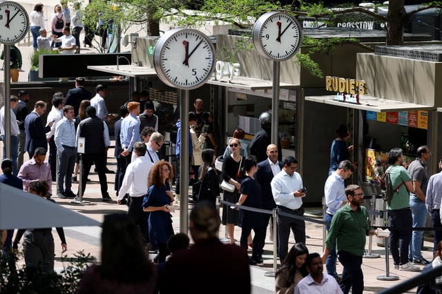 People queue for food in the financial district of Canary Wharf in London, Britain, May 18, 2022. REUTERS/Kevin Coombs/File Photo