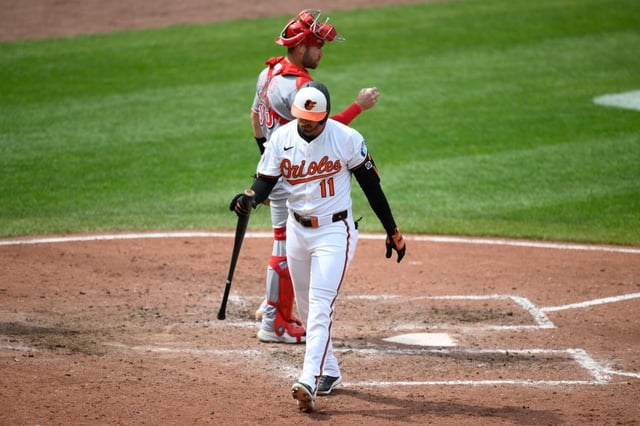 Baltimore Orioles’ Jordan Westburg, front, walks back to the dugout past Cincinnati Reds catcher Austin Wynns, back, after he struck out during the fourth inning of a baseball game, Sunday, April 20, 2025, in Baltimore. (AP Photo/Nick Wass)