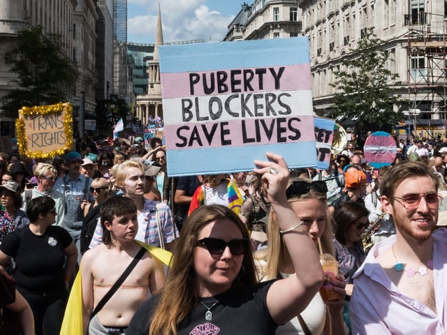 LONDON, UNITED KINGDOM - JULY 27, 2024: Protesters carry placards against the ban on puberty blockers as transgender people and their supporters march through central London during the sixth Trans Pride protest march for transgender freedom and equality in the UK and globally in London, United Kingdom on July 27, 2024. (Photo credit should read Wiktor Szymanowicz/Future Publishing via Getty Images)