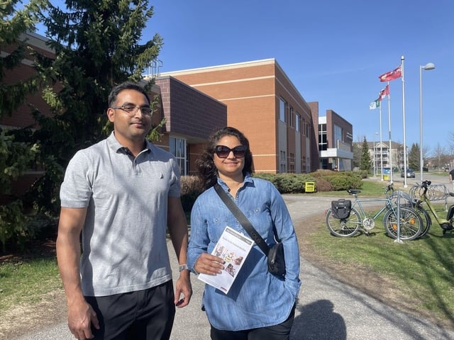 Carleton voters Soumya Dey and Shibani Sharma stand outside of the polling station where they cast their ballots on April 28, 2025. The couple said it was important for them to show up to vote for their first time as Canadian citizens.