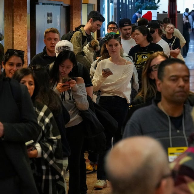 People wait in line to register to vote at a polling station for Canada's federal election, in Toronto, Ontario, Canada April 28, 2025. REUTERS/Arlyn McAdorey