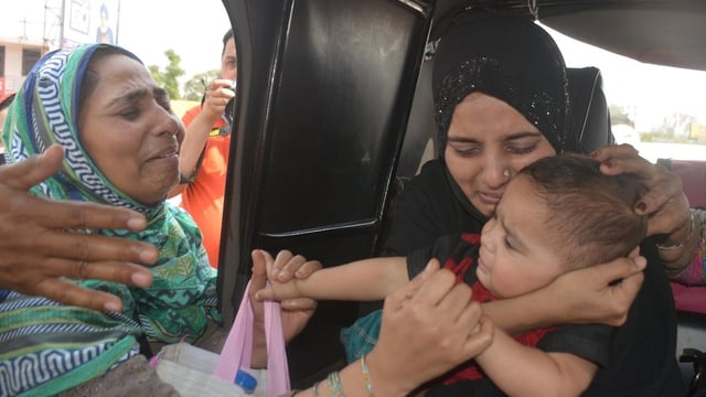 Before crossing over the border at Attari-Wagah border check post, a Pakistan woman (R) bids a teary goodbye to her baby, an Indian citizen, after she was not allowed to accompany her following curbs imposed at the border in wake of Pahalgam terror attack.