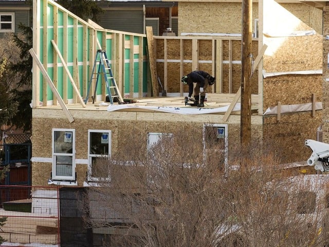 Construction crews work on a multi-unit home near 141 Street and 110A Avenue, in Edmonton Wednesday Jan. 8, 2025. 