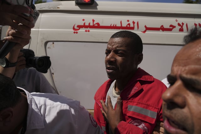 Asaad Al-Nsasrah, a paramedic with the Red Crescent whose colleagues were killed by Israeli army in southern Gaza, arrives at al-Aqsa Hospital in Deir al-Balah, central Gaza, on Tuesday, April 29, 2025, after being released from an Israeli prison. (AP Photo/Abdel Kareem Hana)