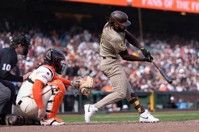San Diego Padres’ Fernando Tatis Jr., right, hits a home run in front of San Francisco Giants catcher Patrick Bailey during the eighth inning of a baseball game in San Francisco, Sunday, Sept. 15, 2024. (AP Photo/Jeff Chiu)