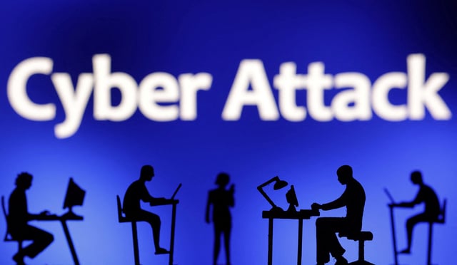 Figurines with computers and smartphones are seen in front of the words "Cyber Attack" in this illustration taken, February 19, 2024. REUTERS/Dado Ruvic/Illustration
