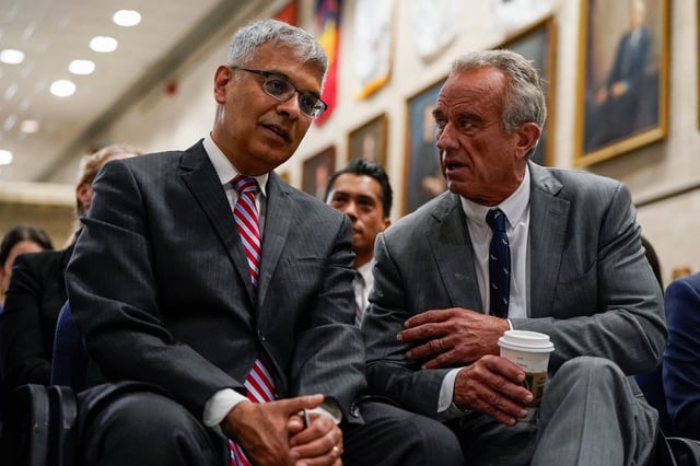U.S. Health and Human Services (HHS) Secretary Robert F. Kennedy, Jr. speaks with Director of the National Institutes of Health Jay Bhattacharya ahead of a press conference announcing of the U.S. Food and Drug Administration's (FDA) intent to phase out the use of petroleum-based synthetic dyes in the nation's food supply, at the Department of Health and Human Services in Washington, D.C., U.S., April 22, 2025. REUTERS/Elizabeth Frantz