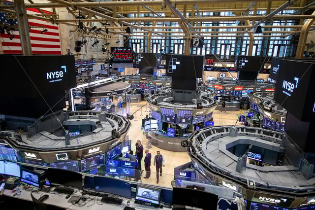 Traders work on the floor of the New York Stock Exchange (NYSE) in New York, US, on Monday, April 21, 2025. US stocks tumbled as President Donald Trump continued to verbally attack Jerome Powell, calling on the Federal Reserve chair to cut rates as signs mount the president's trade war is pushing the economy toward recession.