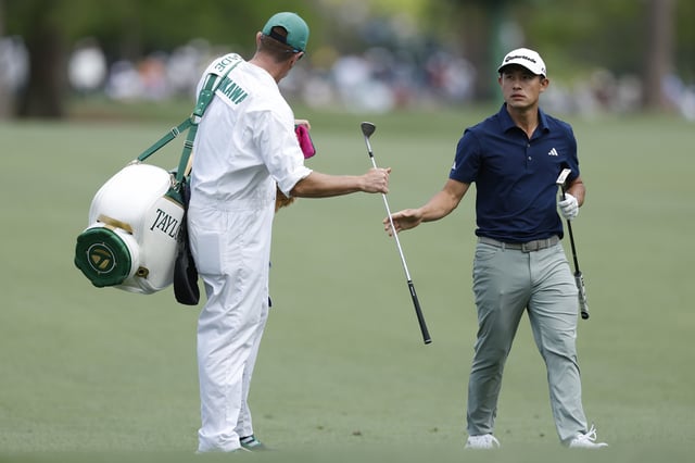 AUGUSTA, GEORGIA - APRIL 12: Collin Morikawa of the United States passes his club to his caddie Jonathan Jakovac during the third round of the 2025 Masters Tournament at Augusta National Golf Club on April 12, 2025 in Augusta, Georgia.