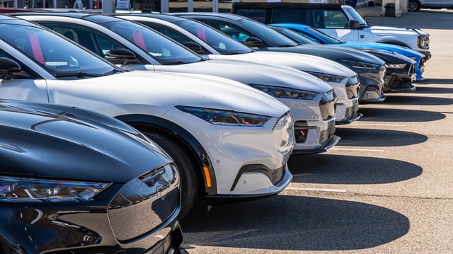 Monroeville, Pennsylvania, USA February 25, 2024 A line of new Ford Mustangs and a Bronco for sale at a dealership on a sunny winter day