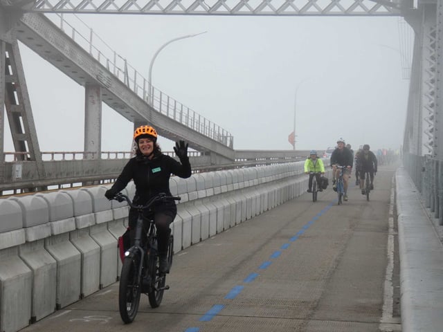 A woman crosses the Richmond-San Rafael Bridge on her e-bike.
