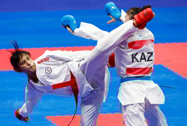 Asian Games - Hangzhou 2022 - Karate - Linping Sports Centre Gymnasium KTE, Hangzhou, China - October 8, 2023 Chinese Taipei's Gu Shiau Shuang in action with Kazakhstan's Moldir Zhangbyrbay during the Women's Kumite - 50kg Gold Medal Contest REUTERS/Kim Kyung-Hoon/File Photo