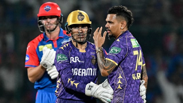 Kolkata Knight Riders' Sunil Narine (R) celebrates with wicketkeeper Rahmanullah Gurbaz (C) after taking the wicket of Delhi Capitals' Tristan Stubbs