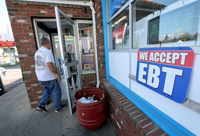 A convenience store advertises that they except EBT cards, Fall River, Massachusetts, October 8.