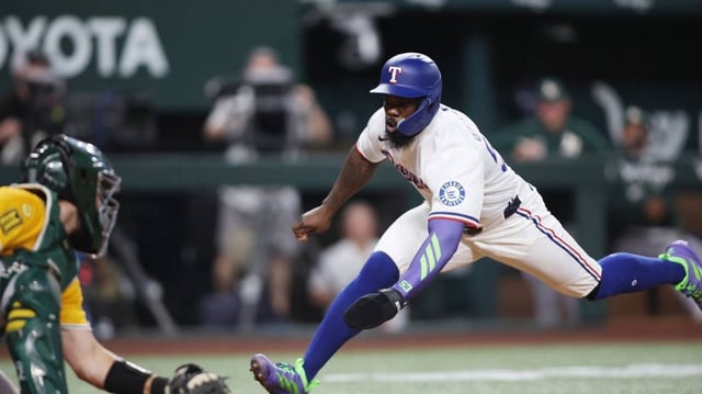 Apr 29, 2025; Arlington, Texas, USA; Texas Rangers outfielder Adolis García (53) attempts to score a run during the second inning against the Oakland Athletics at Globe Life Field. Mandatory Credit: Tim Heitman-Imagn Images