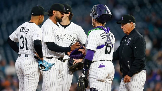 Colorado Rockies manager Bud Black, right, walks to the mound to remove starting pitcher German Marquez, second from left, in the sixth inning of a game against the Atlanta Braves on Tuesday at Coors Field in Denver.