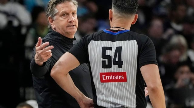 Minneapolis, Minnesota, USA; Minnesota Timberwolves head coach Chris Finch talks with referee Ray Acosta in the fourth quarter of the game with the Brooklyn Nets at Target Center.