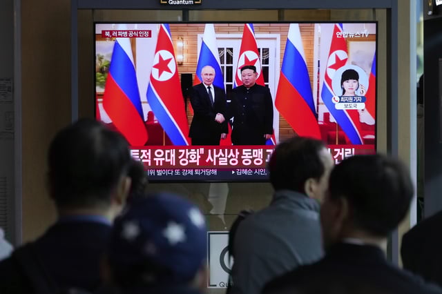 A TV screen shows a file image of North Korean leader Kim Jong Un, right, and Russian President Vladimir Putin in Pyongyang, during a news program at the Seoul Railway Station in Seoul, South Korea, Monday, April 28, 2025.(AP Photo/Ahn Young-joon)