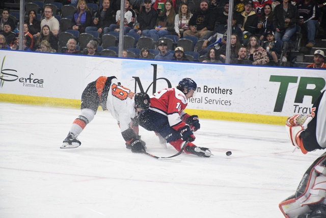 Lethbridge Hurricanes Brayden Edwards is knocked off stride by Jonas Woo of the Medicine Hat Tigers during Game 3 of the WHL's Eastern Conference final at VisitLethbridge.com Arena on Tuesday night.