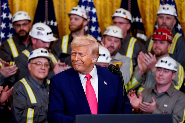 U.S. President Donald Trump reacts next to coal industry workers, on the day he signs energy-related executive orders at the White House in Washington, D.C., U.S., April 8, 2025. REUTERS/Nathan Howard/File Photo