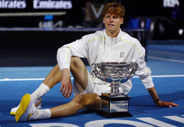 Tennis - Australian Open - Melbourne Park, Melbourne, Australia - January 26, 2025 Italy's Jannik Sinner poses with the trophy after winning the final against Germany's Alexander Zverev REUTERS/Edgar Su
