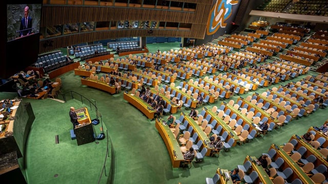 Then-German Chancellor Olaf Scholz speaks to empty rows of seats at the U.N. General Assembly, in New York, Sept. 19, 2023 (DPA photo by Michael Kappeler via AP Images).