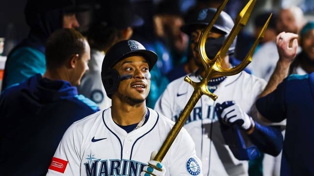 Apr 29, 2025; Seattle, Washington, USA; Seattle Mariners designated hitter Jorge Polanco (7) celebrates in the dugout after hitting a two-run home run against the Los Angeles Angels during the seventh inning at T-Mobile Park. Mandatory Credit: Joe Nicholson-Imagn Images