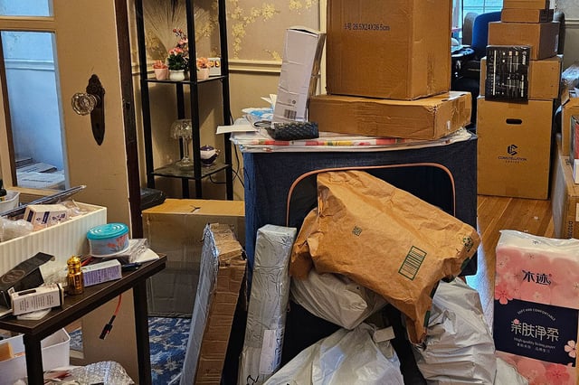 Packages seen in the home of Phillip Dampier, a 57-year-old who orders from Temu and other Chinese e-commerce sites.