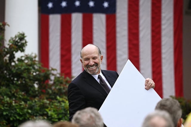 Secretary of Commerce Howard Lutnick holds a chart as  President Donald Trump delivers remarks on tariffs in the White House Rose Garden on April 2, 2025. 