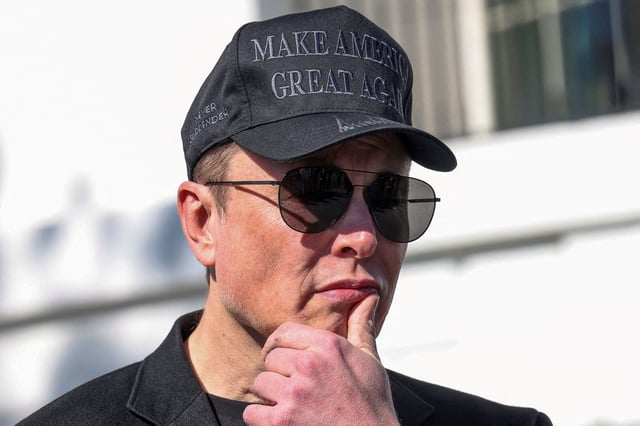 Tesla CEO Elon Musk looks on next to U.S. President Donald Trump talking to the media, at the White House in Washington, D.C., U.S., March 11, 2025. REUTERS/Kevin Lamarque/File Photo