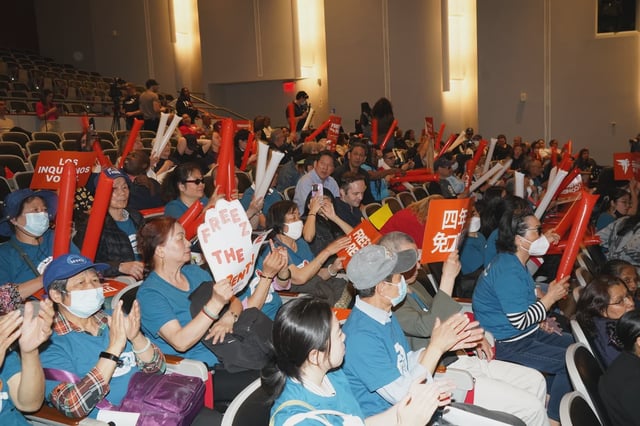 Tenants pack the auditorium at LaGuardia Community College on Wednesday night, waving signs and noisemakers to demand a rent freeze during the Rent Guidelines Board's preliminary vote.