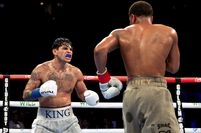 NEW YORK, NEW YORK - APRIL 20: Ryan Garcia (white trunks) reacts against Devin Haney (gray trunks) during their WBC Super Lightweight title bout at Barclays Center on April 20, 2024 in New York City. (Photo by Al Bello/Getty Images)