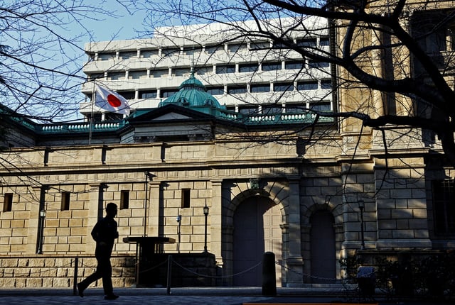 A passerby walks past in front of the Bank of Japan headquarters in Tokyo, Japan January 23, 2025.  REUTERS/Issei Kato