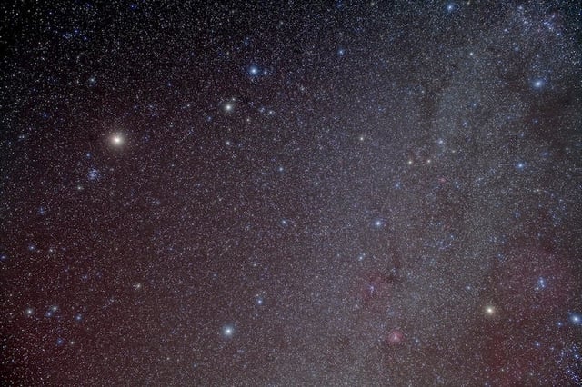 Mars stands near the Beehive Cluster (M44) at upper left in this 2010 astrophoto. The Red Planet again visits the Beehive this month. Credit: Alan Dyer