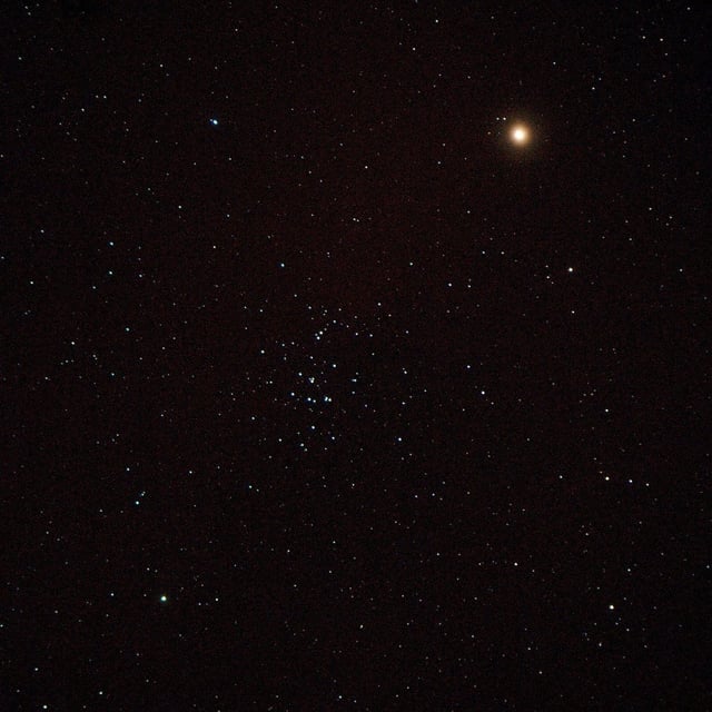 Mars (upper right) skims through the Beehive open cluster (M44). Credit: horstm42 (Flickr, CC BY-NC-ND 2.0)