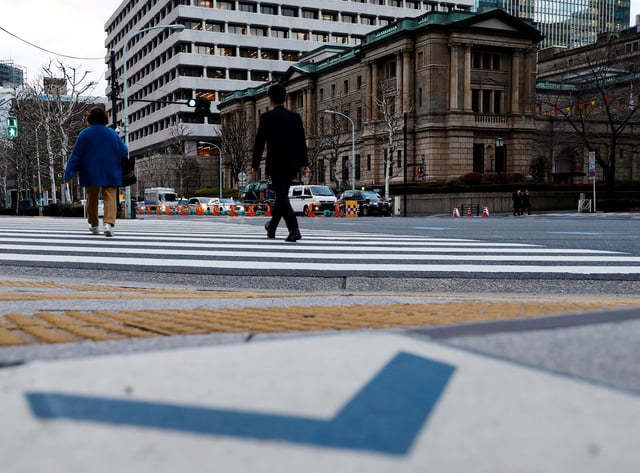 People walk in front of the Bank of Japan building in Tokyo, Japan January 23, 2024. REUTERS/Kim Kyung-Hoon