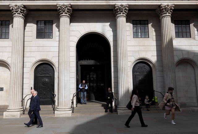 People walk outside the Bank of England building in London, Britain, April 14, 2025. REUTERS/Carlos Jasso/File Photo