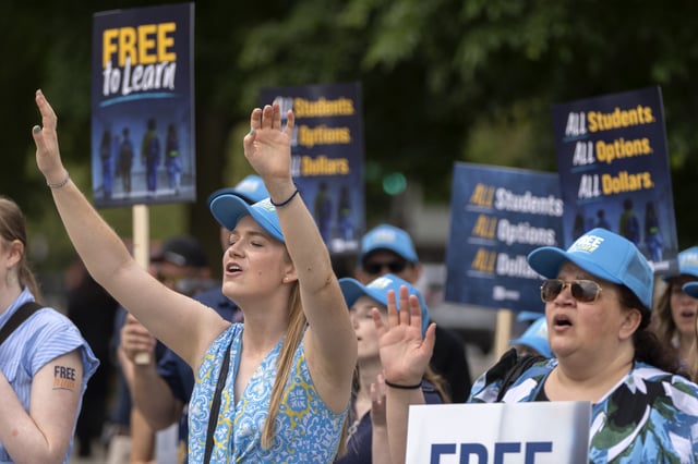 Charter school supporters Pamela Smith of Sterling, Virginia, left, and Tammy-Kay Williams of Fountain Hills, Arizona, right, rally outside of the Supreme Court on Wednesday, April 30, 2025, in Washington.